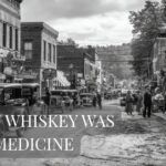 A black-and-white photo shows a busy early 1900s street with vintage cars, people in period clothing, and storefronts. The words “WHEN WHISKEY WAS MEDICINE” and “Old Forester 1920” appear in large text over the image.